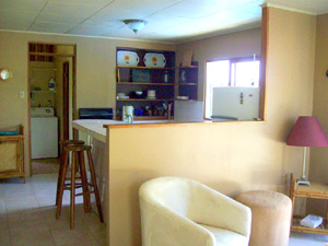 A low wall separates the living room and kitchen.